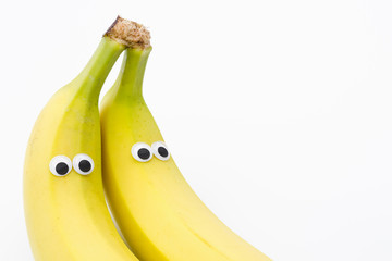 bananas with googly eyes on white background - banana face
