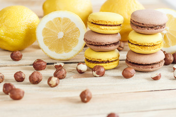 Yellow and brown french macarons with lemon and hazelnuts