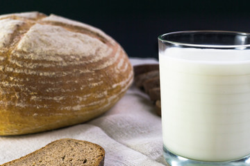 Background food ingredients on the tablecloth. Homemade bread and milk.