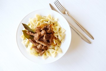Pasta with beef in tomato sauce and laurel leaf spices 