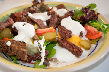 Fresh salad with egg, tomato, bacon and lettuce .