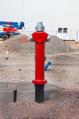 Fototapeta na wymiar New fire hydrant on building site. Street construction. Fire safety.