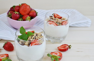 Chocolate muesli with yogurt and strawberries, healthy breakfast