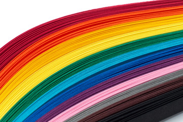 Colored strips of paper for quilling rainbow colors, close-up