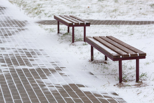 Slippery snow-covered road. A dangerous slippery snow-covered road on a cold winter day with icy benches © Vladimir Zlotnik