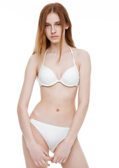 Fototapeta premium Young fit fashion model wearing white bikini