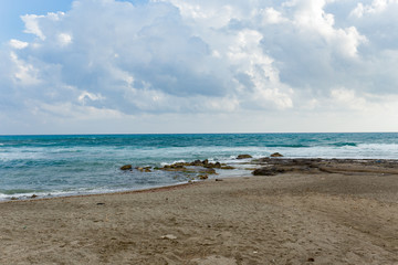 Fototapeta na wymiar Seascape with sandy beach and sky with clouds