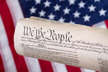 United States Constitution With The American Flag In Background