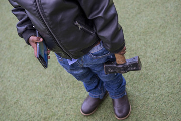 Child breaks telephone with hammer