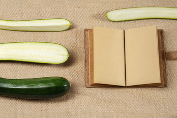 Fresh Zucchini lying on a sackcloth surface