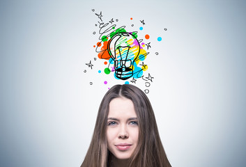 Young girl and colorful light bulb