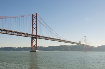Fototapeta na wymiar Big red metal bridge in Lisabon