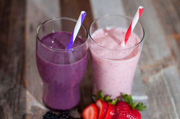 Milkshakes made with fresh blueberries and strawberries in a glass