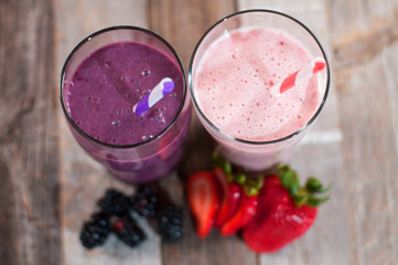 Milkshakes made with fresh blueberries and strawberries in a glass