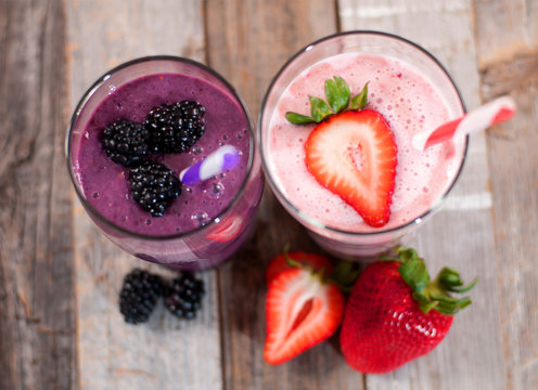 Milkshakes made with fresh blueberries and strawberries in a glass