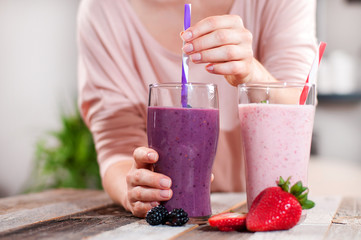 Milkshakes made with fresh blueberries and strawberries in a glass