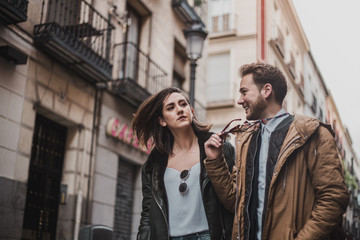 Loving couple walking down the street. Happy friends walking through the city. © Juanje Garrido