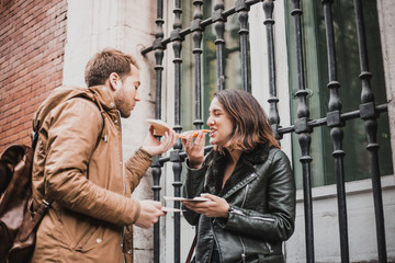 Friends having a good time eating pizza.