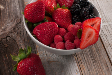Assorted fresh juicy berries in bowls