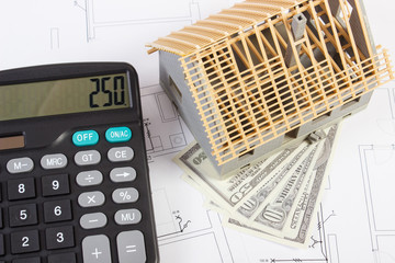 House under construction, calculator and currencies dollar on electrical drawings and diagrams, building home cost concept
