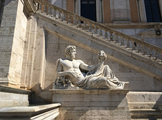 Ancient Roman Statue of the Tiber River God (Tiberinus) in the Piazza del Campidoglio, designed by Michelangelo, in Rome, Italy at the base of stone steps leading to the first floor.