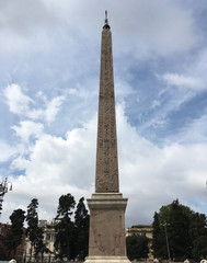Obraz premium Flaminio Obelisk (Obelisco Flaminio) in the Piazza del Popolo in Rome, Italy. Obelisk is from Pharaoh Ramses II of Egypt, 13th Century BC. Erected in the piazza by Pope Sixtus V.
