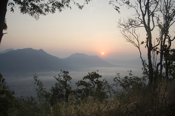 Vew of phu tok mountain with mist and sun at viewpoint in morning and sunrise time