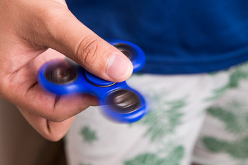 Teenager holding a spinning fidget spinner