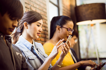 Group of asian Business Friends Sitting Chair Using Modern Gadgets.Business Startup Friendship Teamwork Concept.Creative People Working Together Sale Project.Coworking Wide