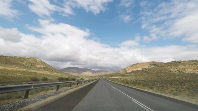 Driving on two lane road crossing the blooming Namaqualand in South Africa. View from car mounted camera.