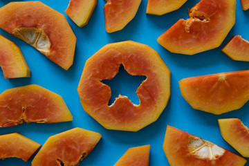 A pieces of orange papaya on blue background.