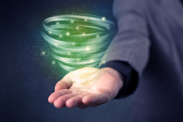 Businessman holding green tornado