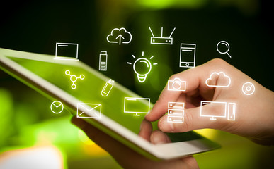 Fingers touching tablet with icons
