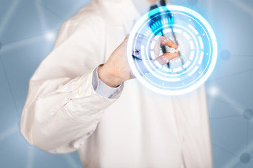 Male doctor holding a pill with glowing circles