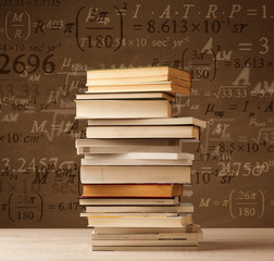 Books on vintage background with math formulas
