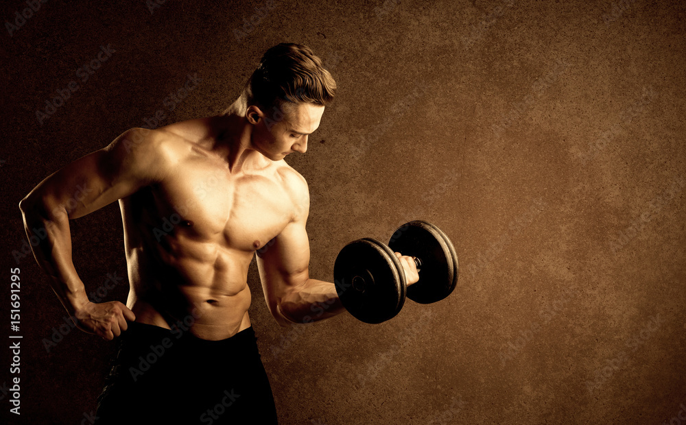 Wall mural muscular fit bodybuilder athlete lifting weight