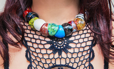 Caucasian woman’s neck with  colorful necklaces