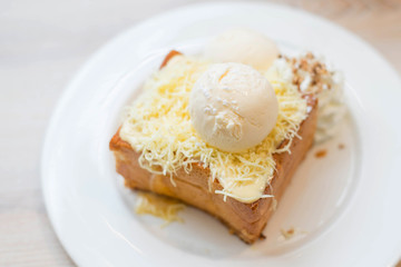 Chesse toast with ice-cream on white dish.