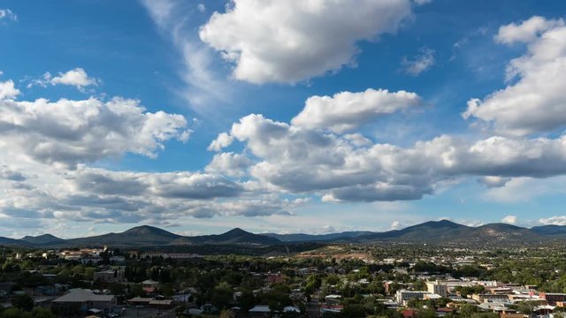 Classic fluffy clouds pass over a small mountain town
