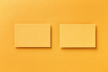 Mockup of two horizontal business cards at golden foil paper background.