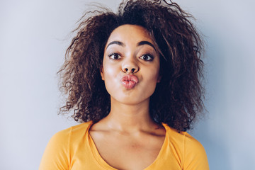  African American girl send kiss, close up portrait .Body language concept