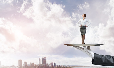 Confident elegant businesswoman presented on metal tray against cityscape background