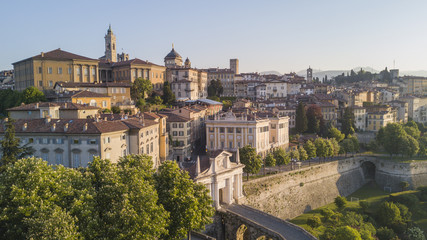 Fototapeta na wymiar Drone aerial view of Bergamo - Old city (Città Alta). One of the beautiful city in Italy. Landscape on the old gate named Porta San Giacomo and historical buildings during a wonderful blu day