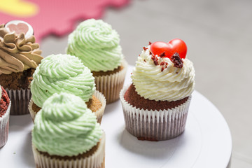 Some muffins cupcakes handmade on a white plate
