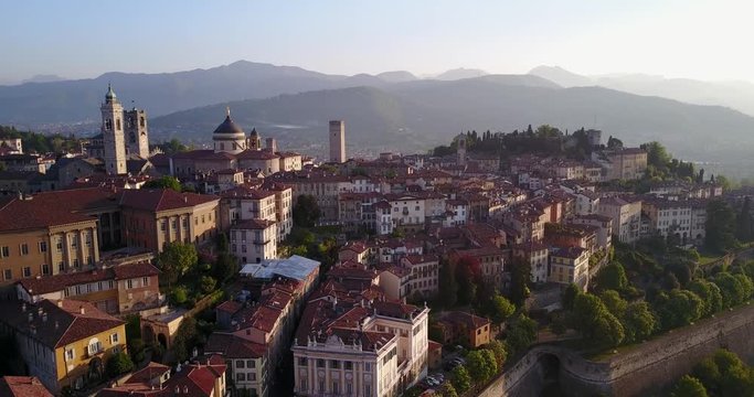 Drone aerial view of Bergamo - Old city (Citta' Alta). One of the beautiful city in Italy. Landscape on the city center and its historical buildings during a wonderful blu day