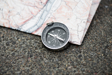 Naklejka na ściany i meble Compass and map on a beautiful wooden surface