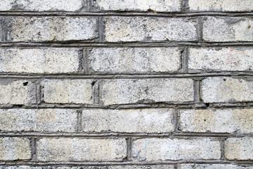 Texture of a brick wall. White brick, the work of a mason, stacker, concrete worker. Construction work, house of white bricks close-up, background