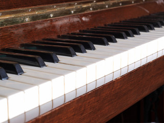 Old piano keys on a dark background