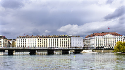 View of the Mont Blanc bridge from the lake promenade with the Hotel des Bergues in the background