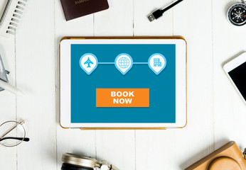 Online booking online table surrounded by travel equipment